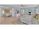 A bedroom with a white bed, multiple windows, and a connected office space at 2926 Royal Fern Ln, Charlotte, NC 28215