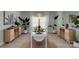 Bright dining room with seating for six, hardwood floors, plants, and matching cabinets at 2926 Royal Fern Ln, Charlotte, NC 28215