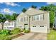 Charming two-story home featuring a two car garage, landscaped yard, and a light blue front door at 2926 Royal Fern Ln, Charlotte, NC 28215