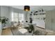 Stylish home office featuring bright light, white furniture, and an area rug on hardwood floors at 2926 Royal Fern Ln, Charlotte, NC 28215