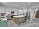 Modern kitchen features an island with seating and stainless steel appliances at 2926 Royal Fern Ln, Charlotte, NC 28215