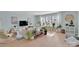 Bright living room with lots of windows, plants, and hardwood flooring at 2926 Royal Fern Ln, Charlotte, NC 28215