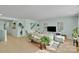 Spacious living room filled with natural light, a sofa, and light-colored flooring at 2926 Royal Fern Ln, Charlotte, NC 28215