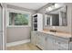 A bathroom featuring a white vanity with granite countertop and a large mirror at 3127 N Center St, Hickory, NC 28601