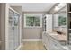 Bright bathroom featuring a glass-enclosed shower and granite countertop vanity at 3127 N Center St, Hickory, NC 28601