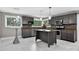 Modern kitchen with stainless steel appliances, marble floors, and central island at 3127 N Center St, Hickory, NC 28601