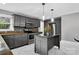 A kitchen with stainless steel appliances, gray cabinets, a kitchen island, and marble floor at 3127 N Center St, Hickory, NC 28601