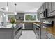 A kitchen featuring stainless steel appliances, gray cabinets, a large window and a kitchen island at 3127 N Center St, Hickory, NC 28601