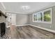 Spacious living room with a stone fireplace, hardwood floors, and plenty of natural light from the windows at 3127 N Center St, Hickory, NC 28601