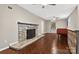 Open living room with stone fireplace, staircase and tiled floors at 3127 N Center St, Hickory, NC 28601