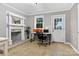Well-lit office featuring a fireplace, desk setup, and a door leading outside at 3127 N Center St, Hickory, NC 28601