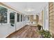 A cozy sunroom with wood-look tile flooring, and a swing to relax on at 3127 N Center St, Hickory, NC 28601