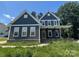 Charming two-story home featuring a covered porch, gray siding, and a well-manicured lawn at 3218 Player Ct, Salisbury, NC 28144