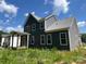 Two-story home with gray siding, a covered porch, and large windows offering plenty of natural light at 3218 Player Ct, Salisbury, NC 28144