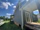 Exterior view showcasing the sliding glass door, gray siding, and covered back porch for outdoor relaxation at 3218 Player Ct, Salisbury, NC 28144