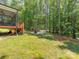 Spacious backyard with a cozy fire pit area and a screened-in porch, ideal for relaxing and entertaining at 3227 Cape Fox Ct, Denver, NC 28037