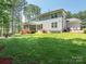 Spacious backyard with a screened-in porch, patio seating area and lush green lawn at 3227 Cape Fox Ct, Denver, NC 28037