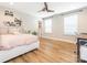Bright bedroom featuring a ceiling fan, and wood-look floors, filled with natural light from two large windows at 3227 Cape Fox Ct, Denver, NC 28037