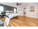 A bedroom showcasing the hardwood floors, large bed, and neutral color palette at 3227 Cape Fox Ct, Denver, NC 28037