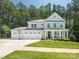 Inviting two-story home with a three-car garage, a basketball hoop, and a charming front porch at 3227 Cape Fox Ct, Denver, NC 28037