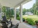 Inviting front porch with rocking chairs and a view of the beautifully landscaped front yard and home at 3227 Cape Fox Ct, Denver, NC 28037