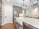 A stylish kitchen featuring a farmhouse sink, stainless steel appliances, and a large kitchen island at 3227 Cape Fox Ct, Denver, NC 28037