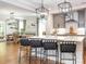 A kitchen featuring a white island with seating, stylish lighting, and stainless steel appliances at 3227 Cape Fox Ct, Denver, NC 28037