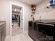 Convenient laundry area with modern washer and dryer units and patterned floors at 3227 Cape Fox Ct, Denver, NC 28037