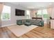 Comfortable living room with a TV and unique, colorful, floor seating, and hardwood floors at 3227 Cape Fox Ct, Denver, NC 28037