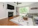 Living room with a fireplace, large windows, comfortable seating, and stylish decor at 3227 Cape Fox Ct, Denver, NC 28037