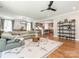 Open-concept living room that features hardwood floors, comfortable seating, and views of the kitchen at 3227 Cape Fox Ct, Denver, NC 28037