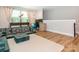 A living room featuring hardwood floors, modern decor, and a large window providing natural light at 3227 Cape Fox Ct, Denver, NC 28037