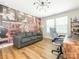 Office space with modern desk, comfortable chair, large exposed brick wall, and hardwood floors at 3227 Cape Fox Ct, Denver, NC 28037