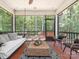 Relaxing screened-in porch with a comfortable lounge area and views of the surrounding trees at 3227 Cape Fox Ct, Denver, NC 28037
