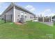 A well-maintained backyard featuring lush green grass, a patio, and a privacy fence at 3317 Black Cherry Dr, Monroe, NC 28110