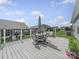 Spacious deck with outdoor dining set, chairs, umbrella, and a view of the backyard at 3317 Black Cherry Dr, Monroe, NC 28110