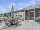 Outdoor deck with a dining table, seating, umbrella, and a view of the yard at 3317 Black Cherry Dr, Monroe, NC 28110