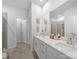 Bright bathroom featuring double sinks, white cabinets, quartz countertops, and modern fixtures at 3317 Black Cherry Dr, Monroe, NC 28110
