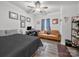 A bedroom with a bed, desk, sofa, and ceiling fan offering a functional and comfortable space at 3317 Black Cherry Dr, Monroe, NC 28110
