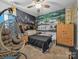A bedroom with a hanging chair, accent wall, ceiling fan, and furniture offering comfort and style at 3317 Black Cherry Dr, Monroe, NC 28110