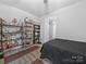 A bedroom showcasing shelves, a ceiling fan, and neutral walls providing versatile space at 3317 Black Cherry Dr, Monroe, NC 28110