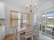 Dining room features a modern chandelier, a table with seating for six, and a sliding glass door at 3317 Black Cherry Dr, Monroe, NC 28110
