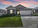 Charming single-Gathering home with a well-manicured lawn and two-car garage at dusk at 3317 Black Cherry Dr, Monroe, NC 28110