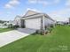 Lovely gray home with a two-car garage, well-kept lawn, and manicured landscaping at 3317 Black Cherry Dr, Monroe, NC 28110