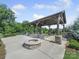 Outdoor fire pit with a covered seating area, perfect for cozy evenings and entertaining guests at 3317 Black Cherry Dr, Monroe, NC 28110