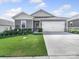 Charming single-story home with a well-manicured lawn, attached garage, and beautiful landscaping at 3317 Black Cherry Dr, Monroe, NC 28110