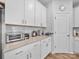 Cozy kitchen featuring granite countertops, white cabinetry, and stainless steel appliances at 3317 Black Cherry Dr, Monroe, NC 28110