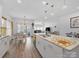 Open concept kitchen with stainless appliances, large island, and dining area with chandelier lighting at 3317 Black Cherry Dr, Monroe, NC 28110