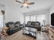 Inviting living room with stylish sofas, wood floors, ceiling fan, and large windows at 3317 Black Cherry Dr, Monroe, NC 28110