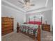 Bedroom featuring a decorative bed frame, ceiling fan, and dresser offering a relaxing retreat at 3317 Black Cherry Dr, Monroe, NC 28110